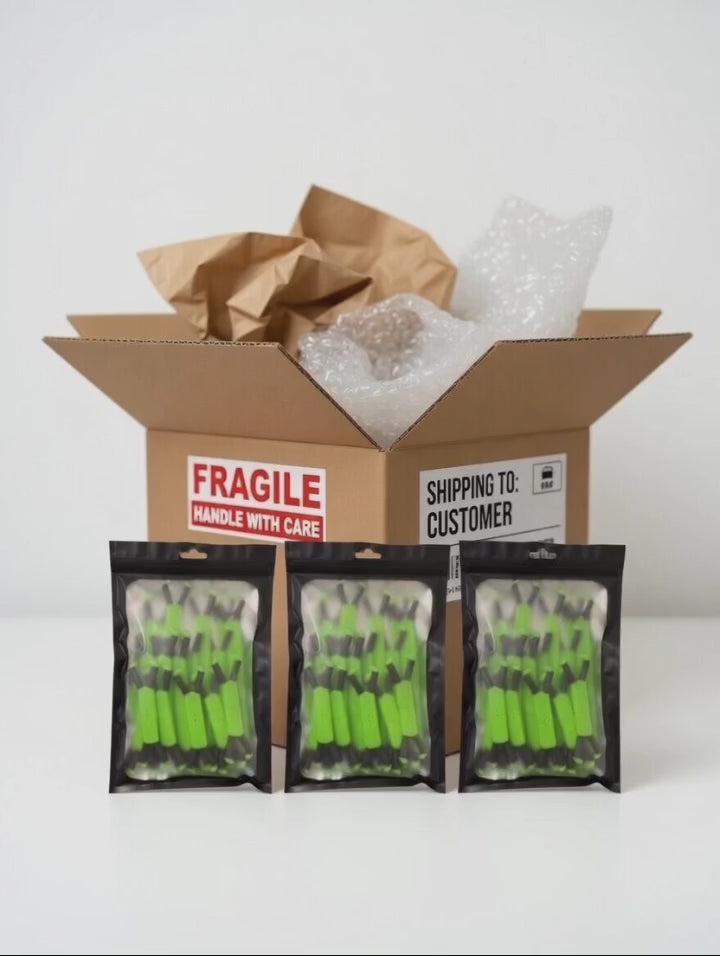 Open cardboard box with bubble wrap and brown paper, containing three packages of Radiant Grove Green multi-pack branch spreaders being packed by hand